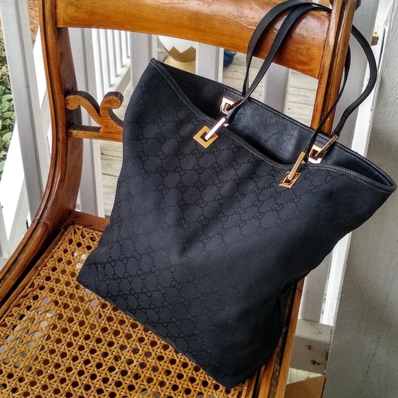 Gucci Handbags - Authentic Gucci GG black gold tote bag purse